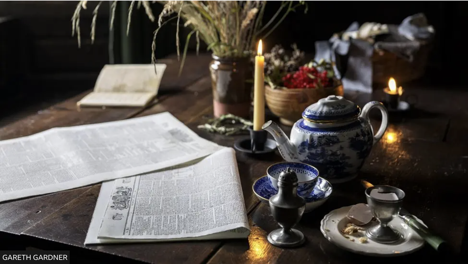 Everyday items such as newspapers and tea sets aim to give a sense of life at the cottage