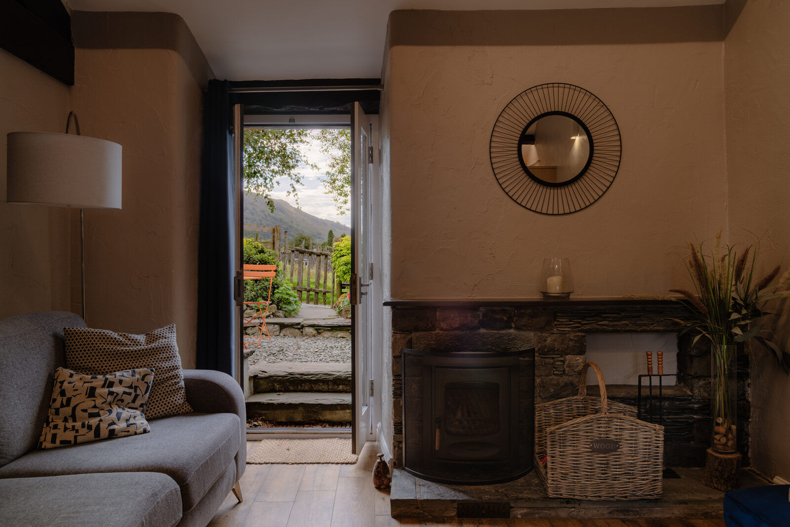 Cosy self catering cottage living room with a wood burner and fell views at The Yan, Grasmere