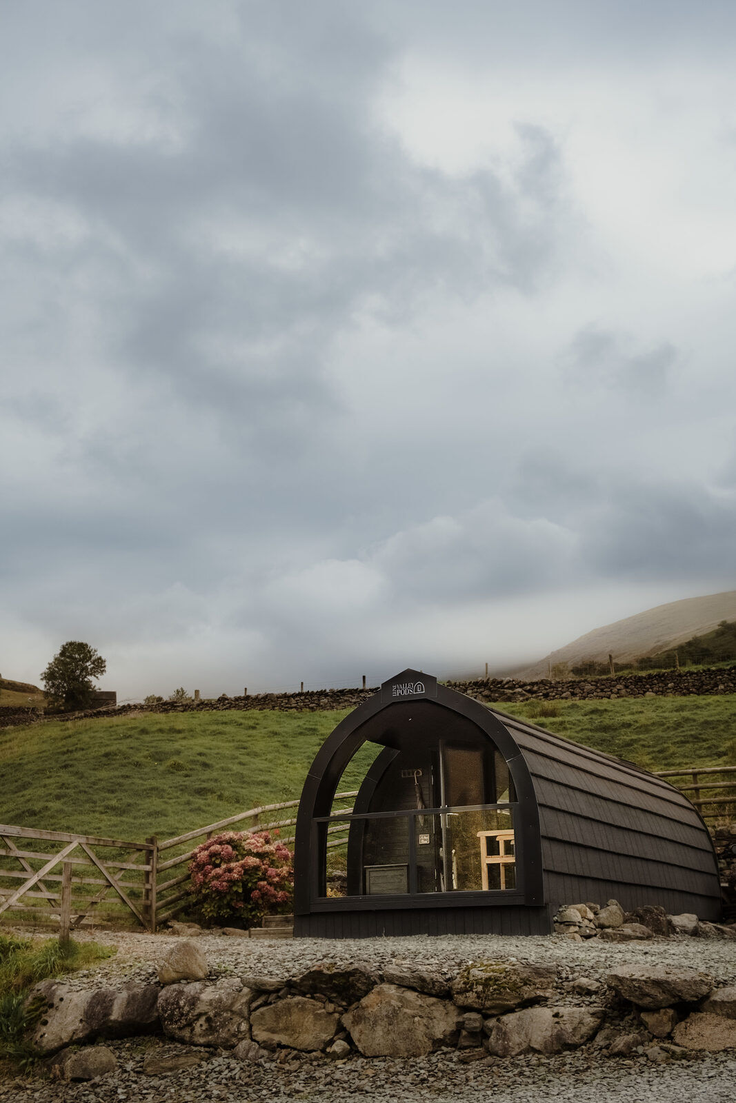 One of The Lookouts glamping pods at Broadrayne Farm, Grasmere, below the fells on a misty autumn day