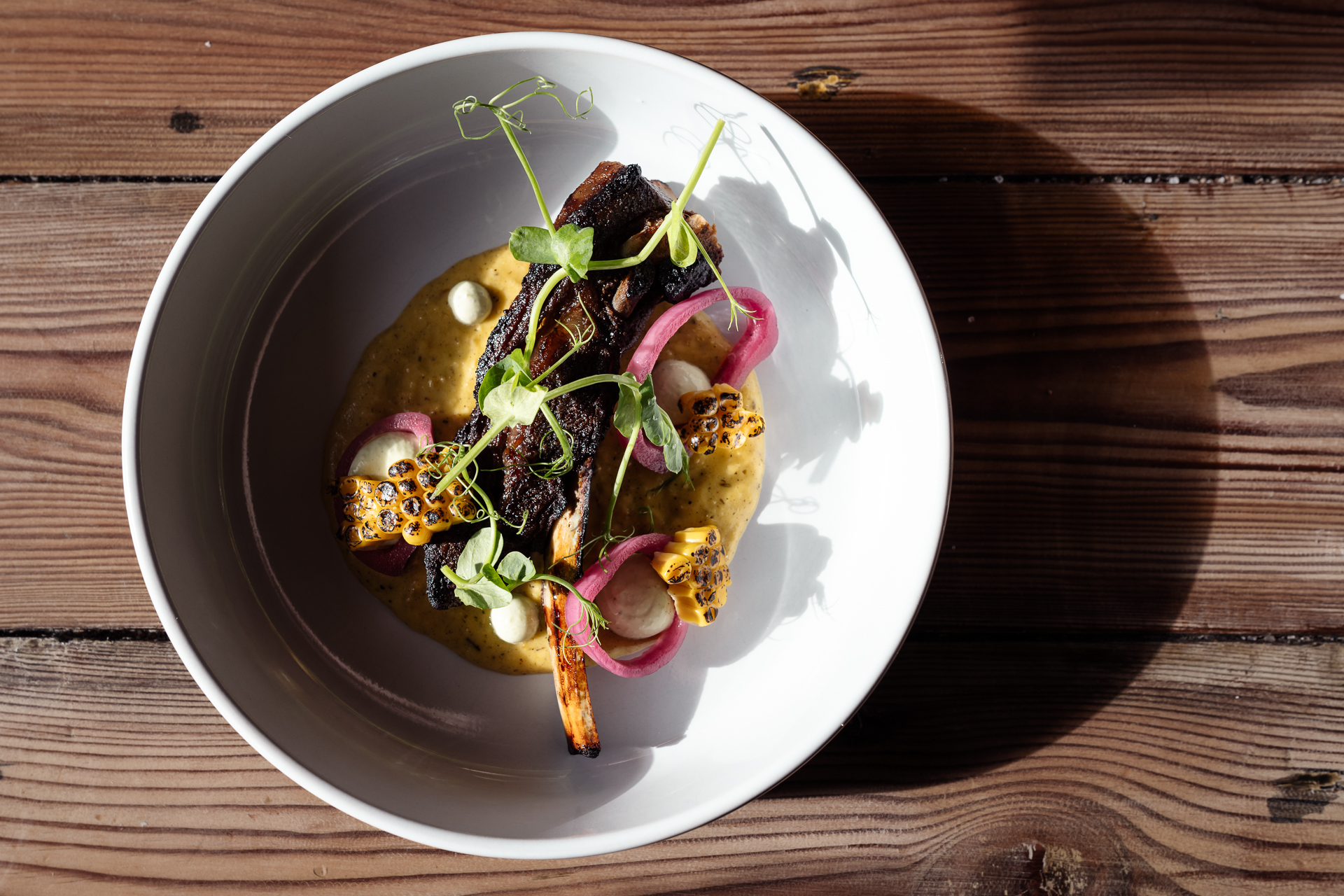 Slow cooked beef rib with charred corn, pickled red onion and pea shoots at The Yan Bistro in Grasmere